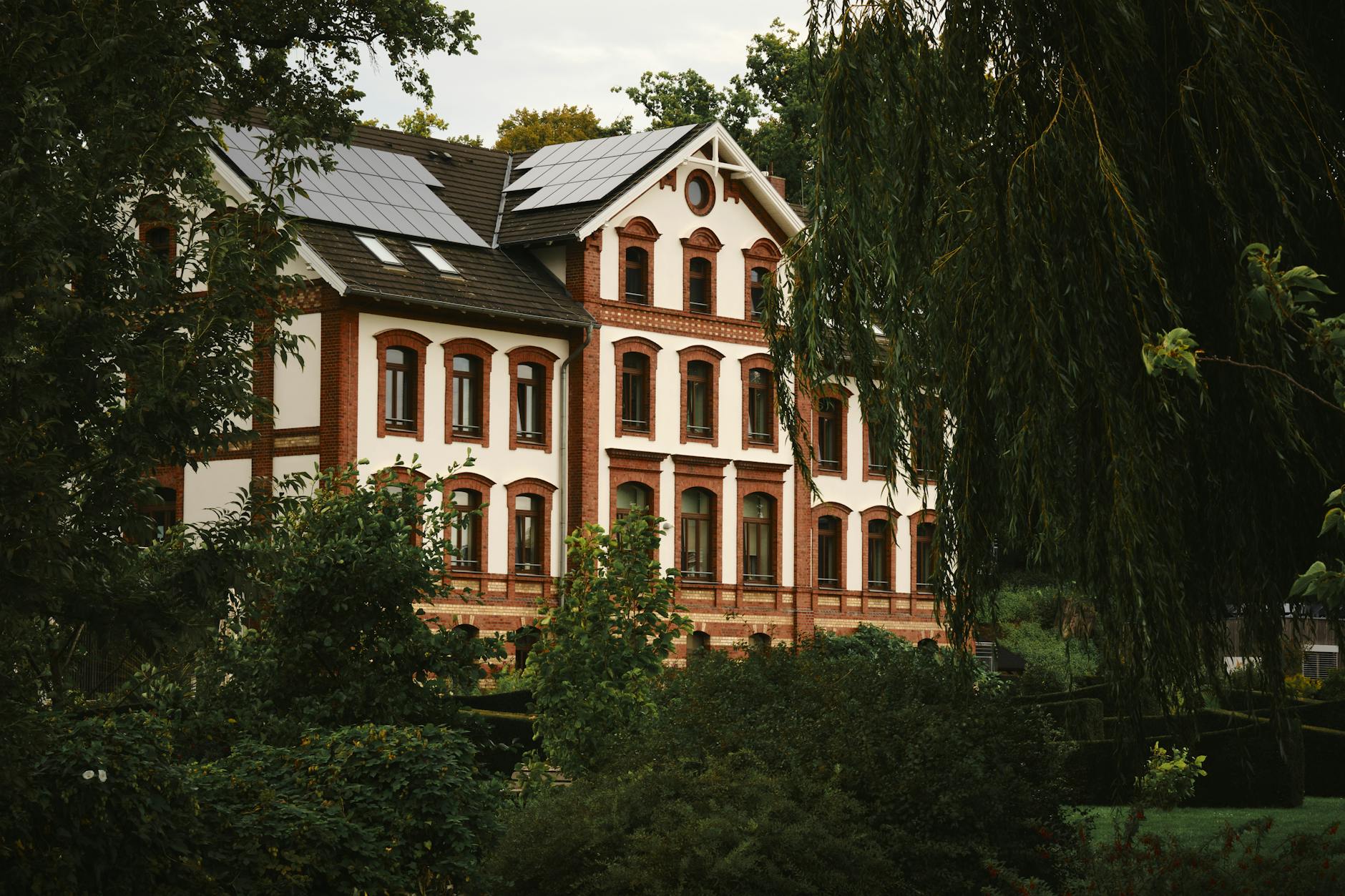 Discover a beautifully preserved historic villa surrounded by lush greenery in Waren (Müritz), Germany.